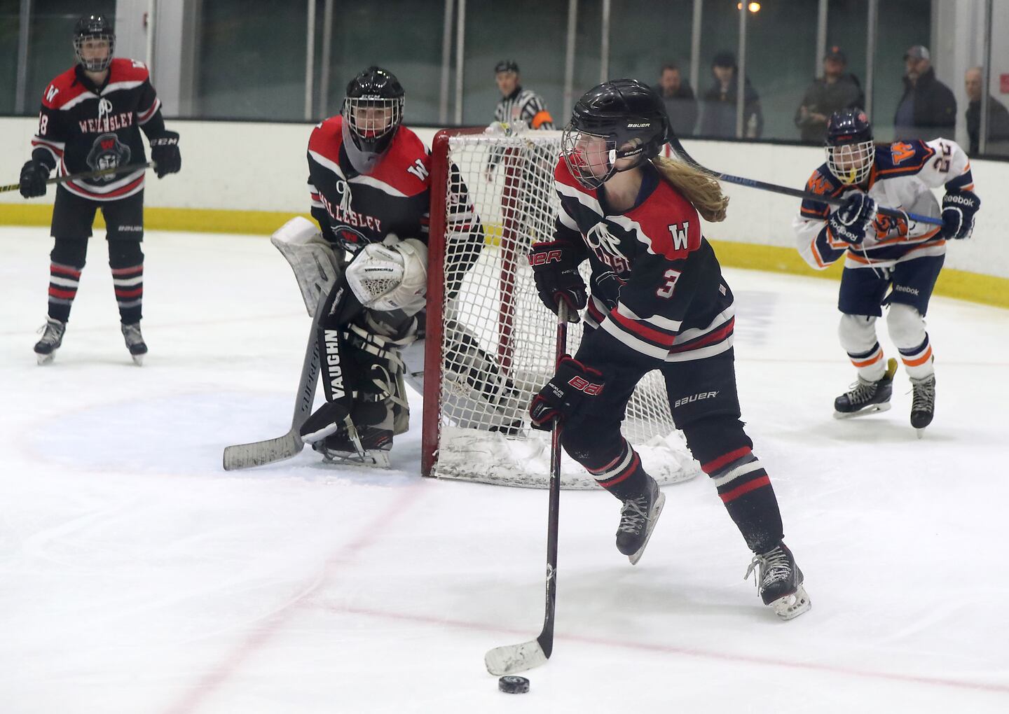 Wellesley’s Emily Rouke (3) looks at her options while controlling the puck behind he own net.
