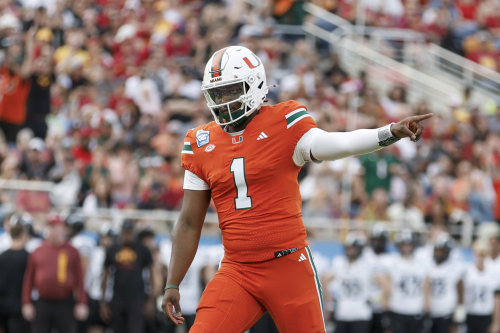 ORLANDO, FL - DECEMBER 28: Miami Hurricanes quarterback Cam Ward (1) reacts after throwing a touchdown pass during the game between the Miami Hurricanes and the Iowa State Cyclones on December 28, 2024 at Camping World Stadium in Orlando, Fl. (Photo by David Rosenblum/Icon Sportswire)