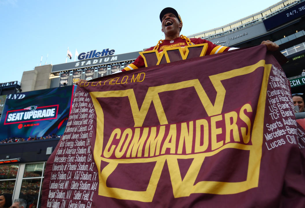 FOXBOROUGH, MASSACHUSETTS - NOVEMBER 05: A Washington Commanders fan holds a flag during the game between the Washington Commanders and the New England Patriots at Gillette Stadium on November 05, 2023 in Foxborough, Massachusetts. (Photo by Adam Glanzman/Getty Images)