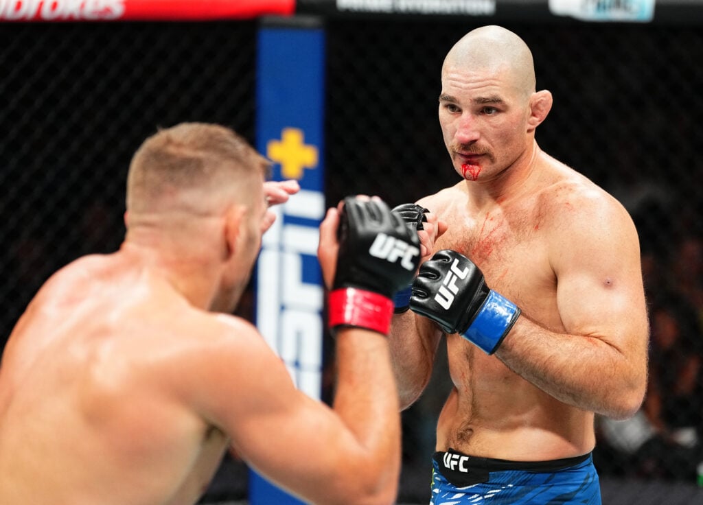 (R-L) Sean Strickland battles Dricus Du Plessis of South Africa in the UFC middleweight championship fight during the UFC 312 event at Qudos Bank A...