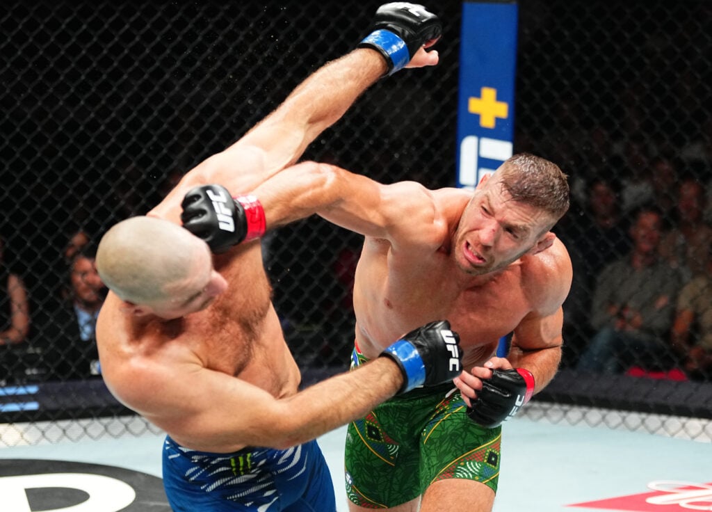 (R-L) Dricus Du Plessis of South Africa punches Sean Strickland in the UFC middleweight championship fight during the UFC 312 event at Qudos Bank A...