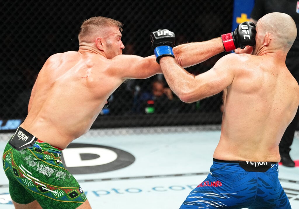 (L-R) Dricus Du Plessis of South Africa punches Sean Strickland in the UFC middleweight championship fight during the UFC 312 event at Qudos Bank A...
